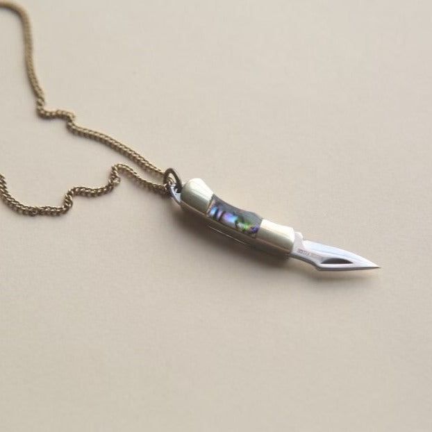 Wondering what a fashion knife necklace is